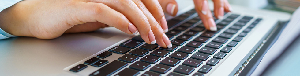 fingers typing on a keyboard